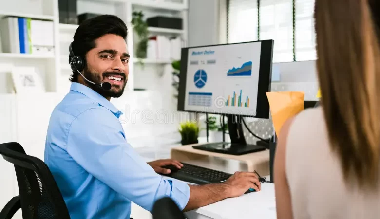 Firozabad-smiling-indian-man-working-as-customer-support-operator-headset-call-center-portrait-sales-agent-sitting-desk